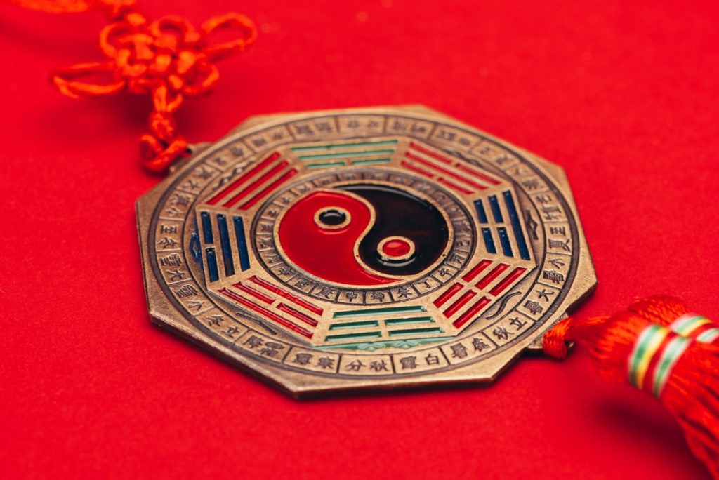 close-up shot of traditional chinese yin and yang talisman on red surface